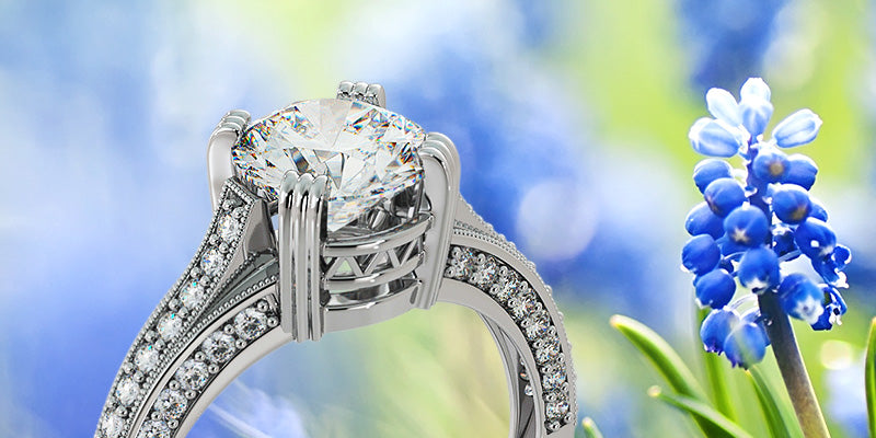 Silver ring with diamonds on a blurred natural background