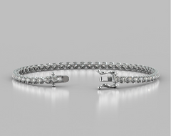 Silver bracelet with clear stones on a gray background